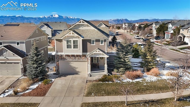 view of front of home with a mountain view and a garage