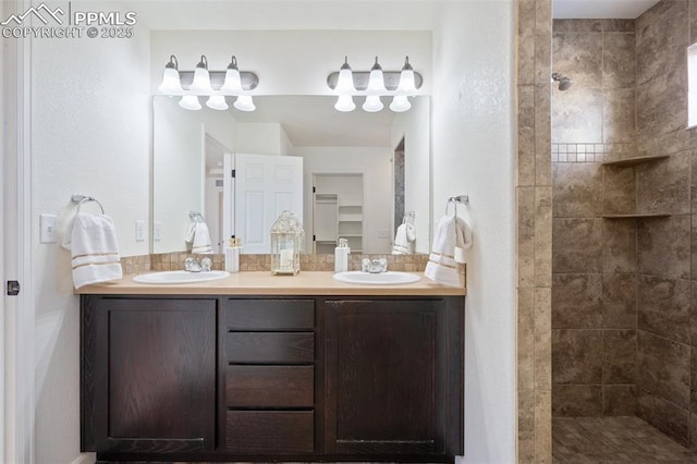 bathroom featuring vanity and tiled shower