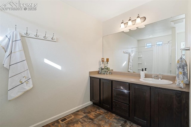 bathroom featuring curtained shower and vanity