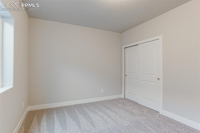 unfurnished bedroom featuring a closet and carpet flooring