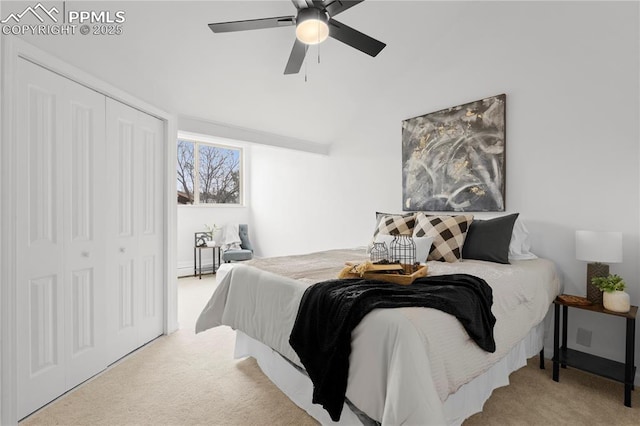 carpeted bedroom featuring vaulted ceiling, ceiling fan, and a closet