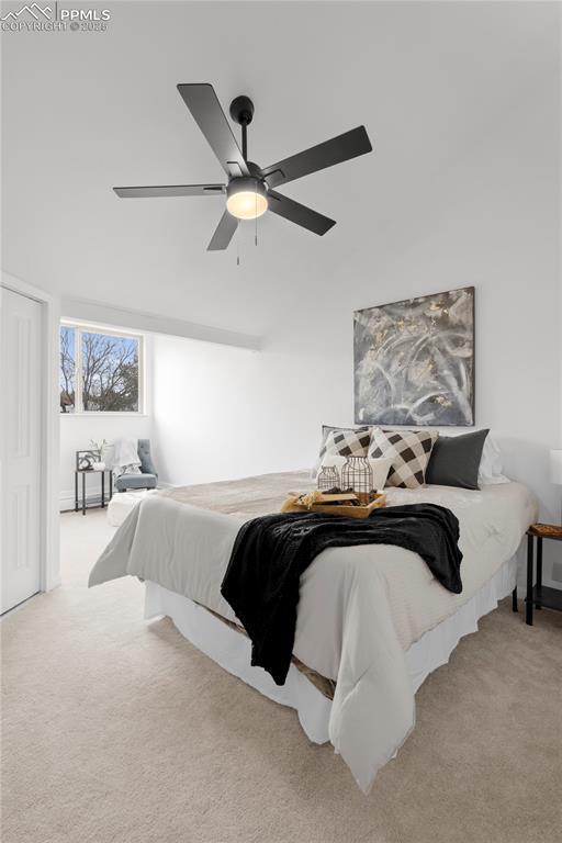 bedroom featuring light colored carpet and ceiling fan