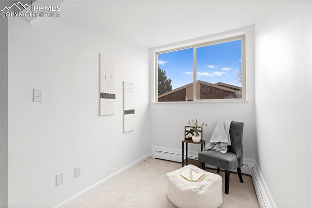 living area with a baseboard radiator and light carpet