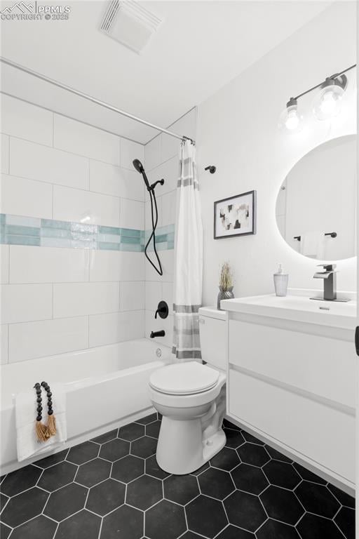 full bathroom featuring toilet, tile patterned flooring, shower / tub combo, and vanity