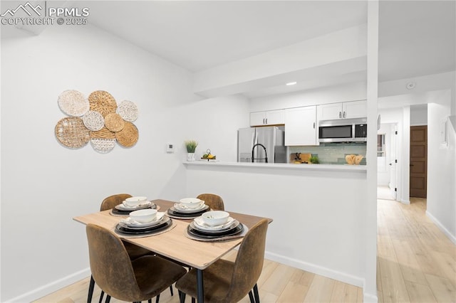 dining room with light hardwood / wood-style floors