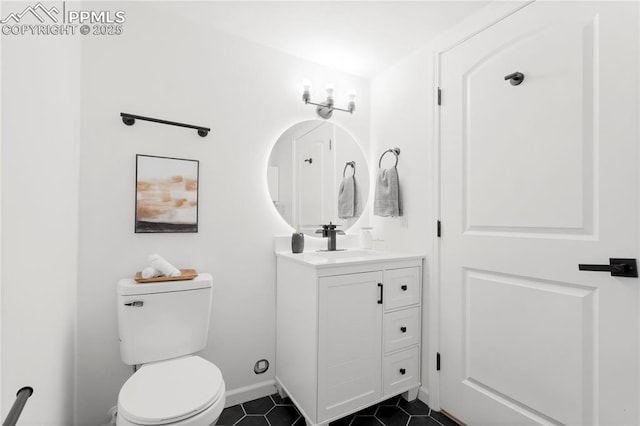 bathroom with toilet, tile patterned floors, and vanity