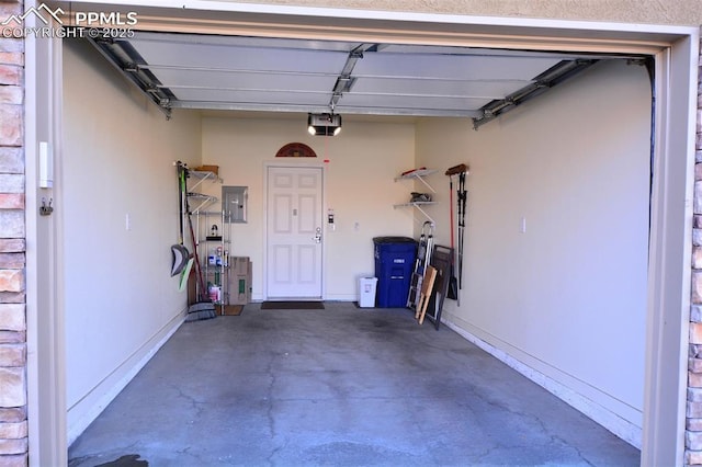 garage with electric panel and a garage door opener