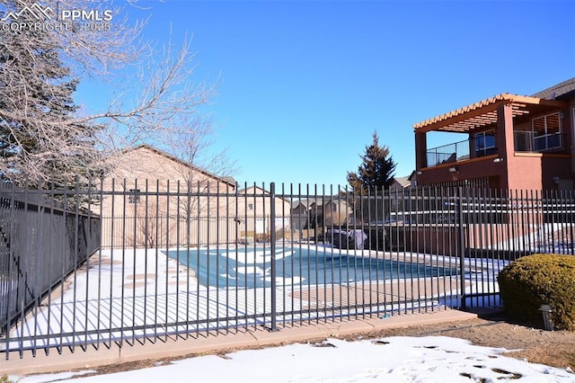 snow covered pool featuring a patio area