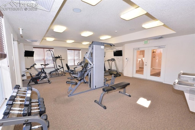 gym featuring french doors and a textured ceiling