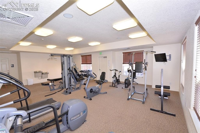 exercise room featuring a textured ceiling