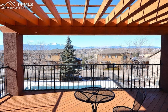 wooden terrace with a pergola and a mountain view