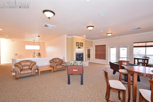 interior space with a notable chandelier, french doors, light carpet, and crown molding