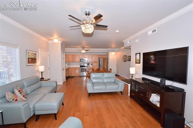 living room with crown molding, ceiling fan, and light hardwood / wood-style flooring