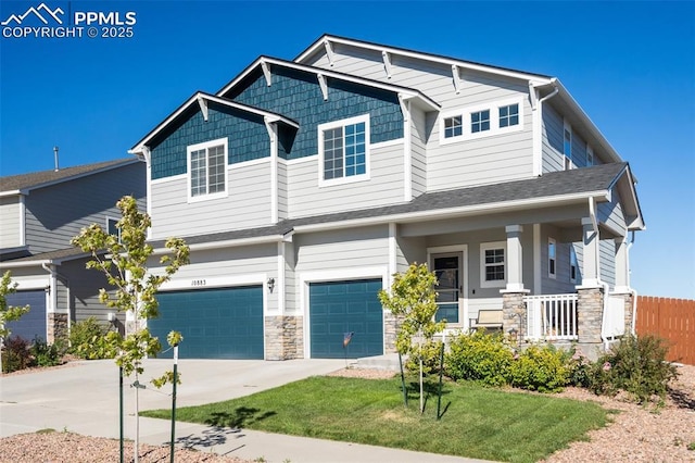 craftsman house featuring a garage, covered porch, and a front yard