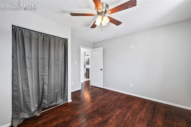 unfurnished bedroom with a textured ceiling, ceiling fan, and dark hardwood / wood-style floors