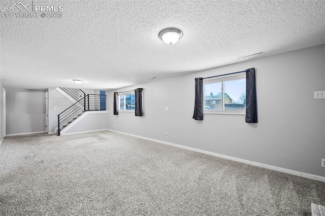 basement with a textured ceiling and carpet