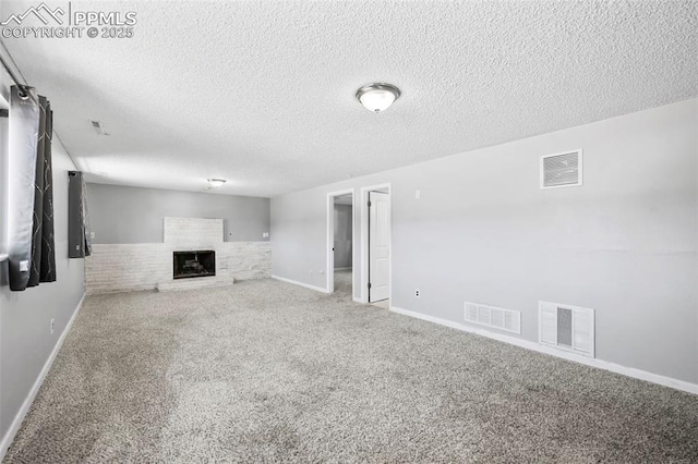 unfurnished living room with a textured ceiling and carpet flooring