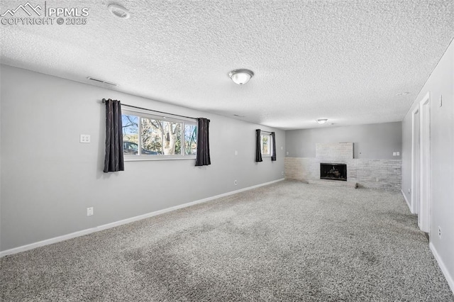 basement featuring a textured ceiling and carpet flooring