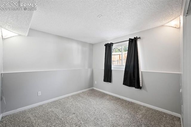 carpeted spare room featuring a textured ceiling