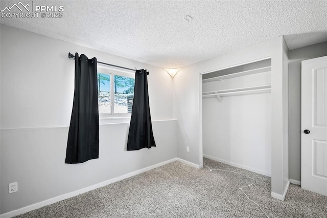 unfurnished bedroom with a textured ceiling, a closet, and carpet floors