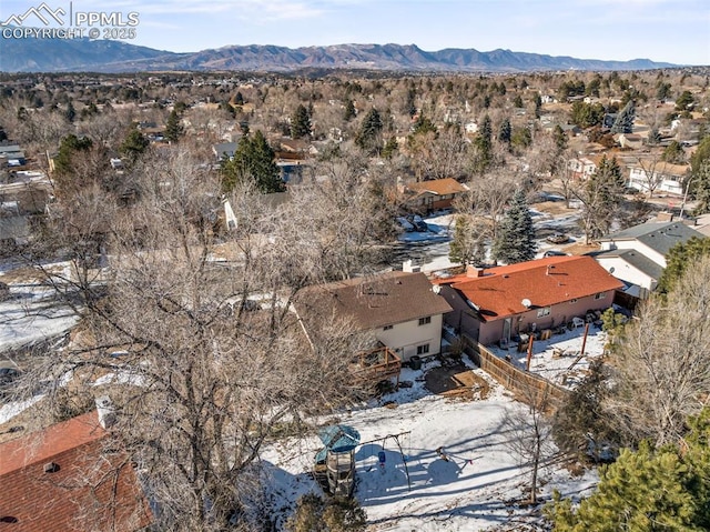 snowy aerial view featuring a mountain view