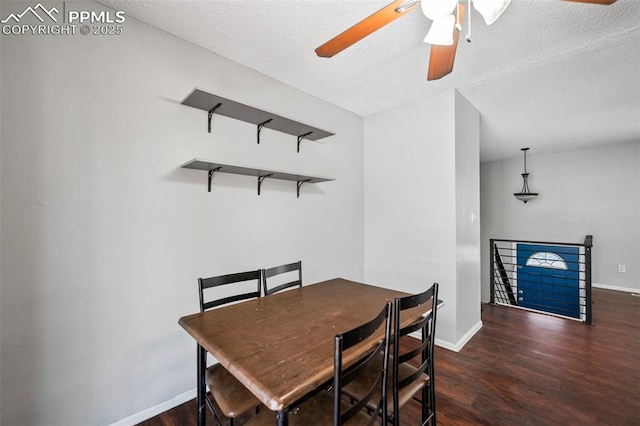 dining space with a textured ceiling, ceiling fan, and dark hardwood / wood-style flooring