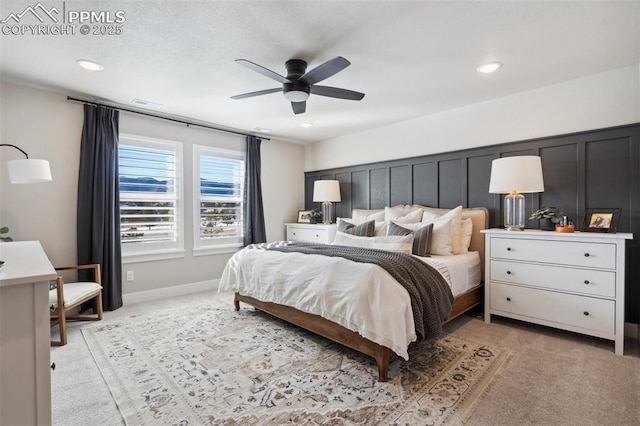 bedroom with ceiling fan and light colored carpet