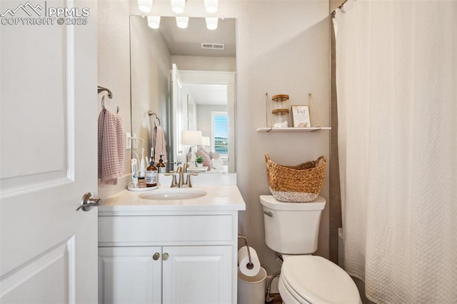 bathroom with toilet and vanity