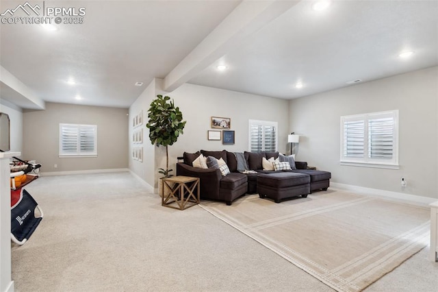 carpeted living room featuring a healthy amount of sunlight and beamed ceiling