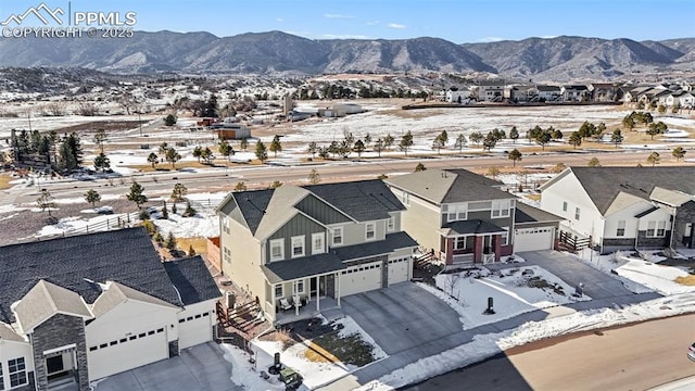 snowy aerial view with a mountain view