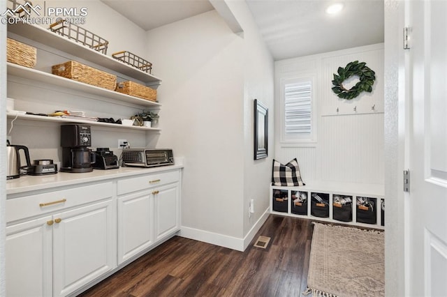 interior space with white cabinets and dark hardwood / wood-style floors