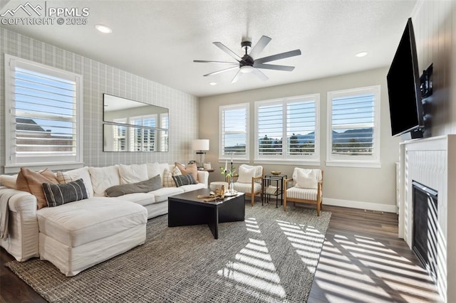 living room with ceiling fan and dark hardwood / wood-style floors