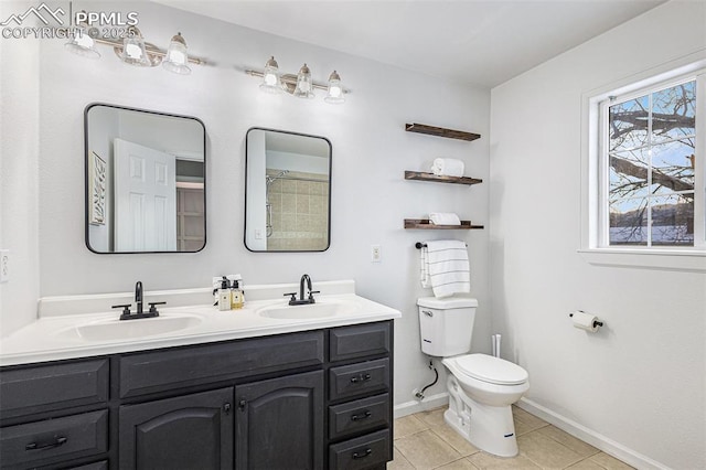 bathroom featuring tile patterned floors, toilet, and vanity