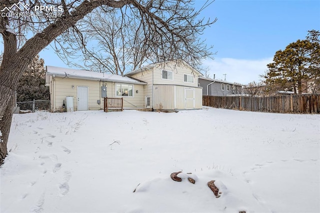 view of snow covered rear of property