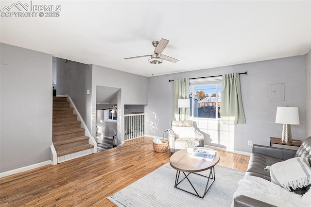 living room with wood-type flooring and ceiling fan