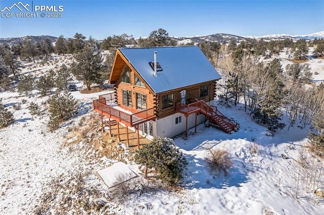 snowy aerial view featuring a mountain view