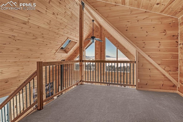 additional living space featuring lofted ceiling with skylight, ceiling fan, carpet, and wood ceiling