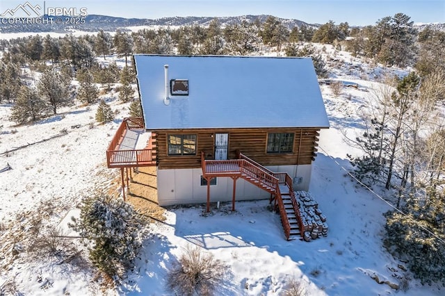 view of front facade with a deck with mountain view