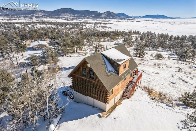 snowy aerial view featuring a mountain view