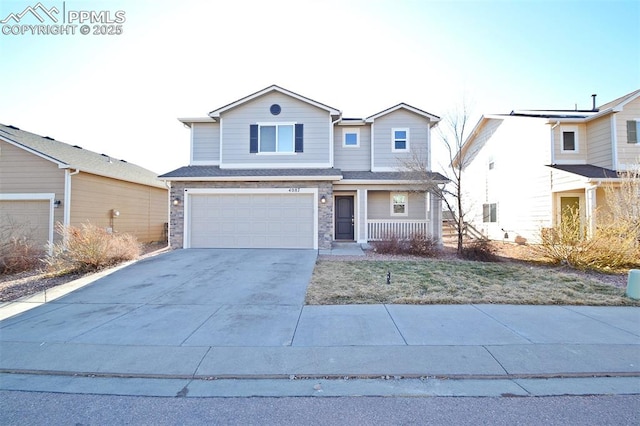 traditional home with covered porch, stone siding, an attached garage, and driveway