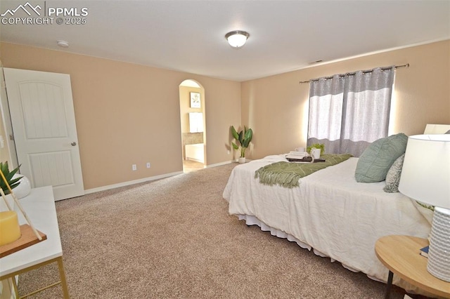 carpeted bedroom with ensuite bath