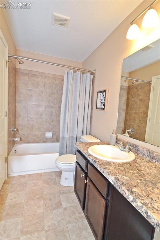 full bathroom with vanity, toilet, and shower / tub combo