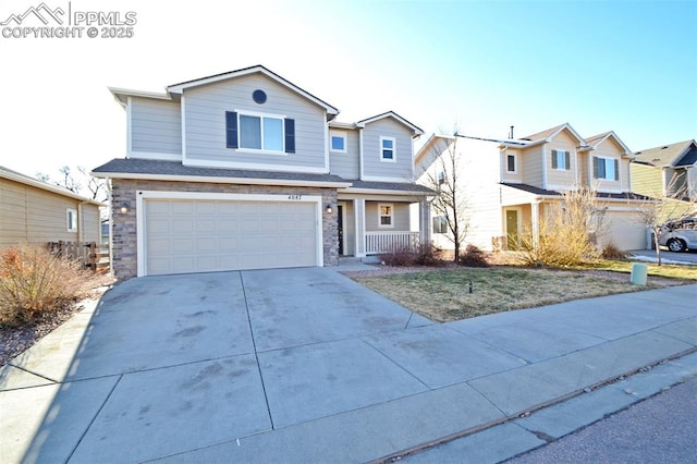 traditional-style house featuring a garage, stone siding, driveway, and a residential view