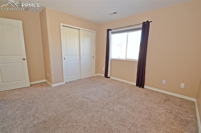 unfurnished bedroom with carpet flooring and a closet