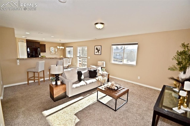 living room with carpet and a chandelier