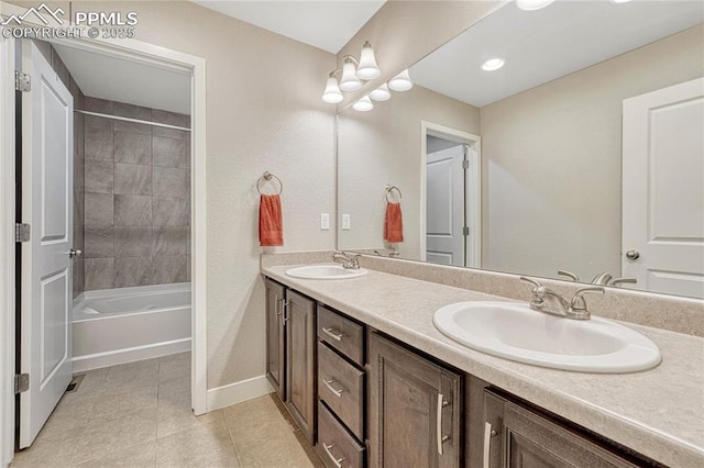 bathroom with vanity, tile patterned flooring, and tiled shower / bath combo