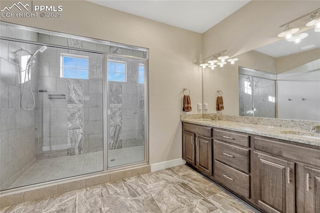 bathroom with vanity and a shower with shower door