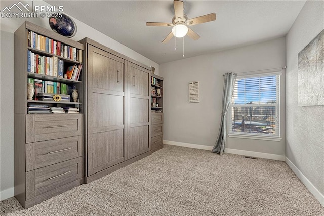 unfurnished bedroom with light colored carpet and ceiling fan