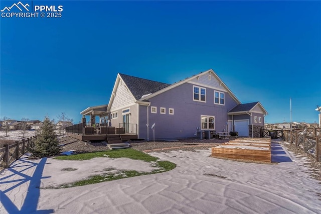 rear view of house featuring a wooden deck, a garage, and central AC