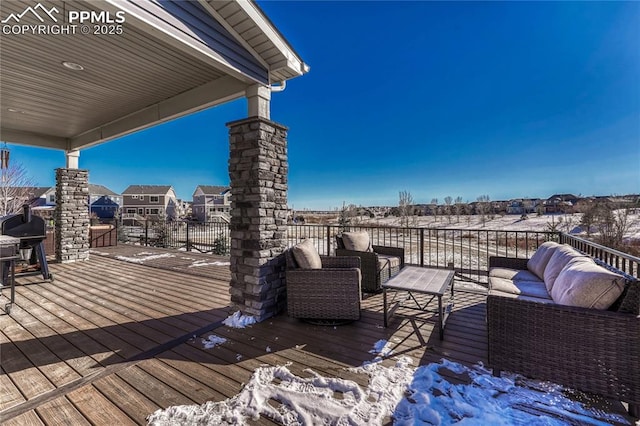 snow covered deck with an outdoor living space